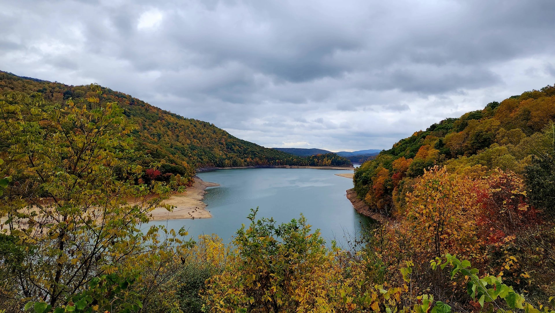 Lake Moomaw surrounded by forested mountains displaying fall color