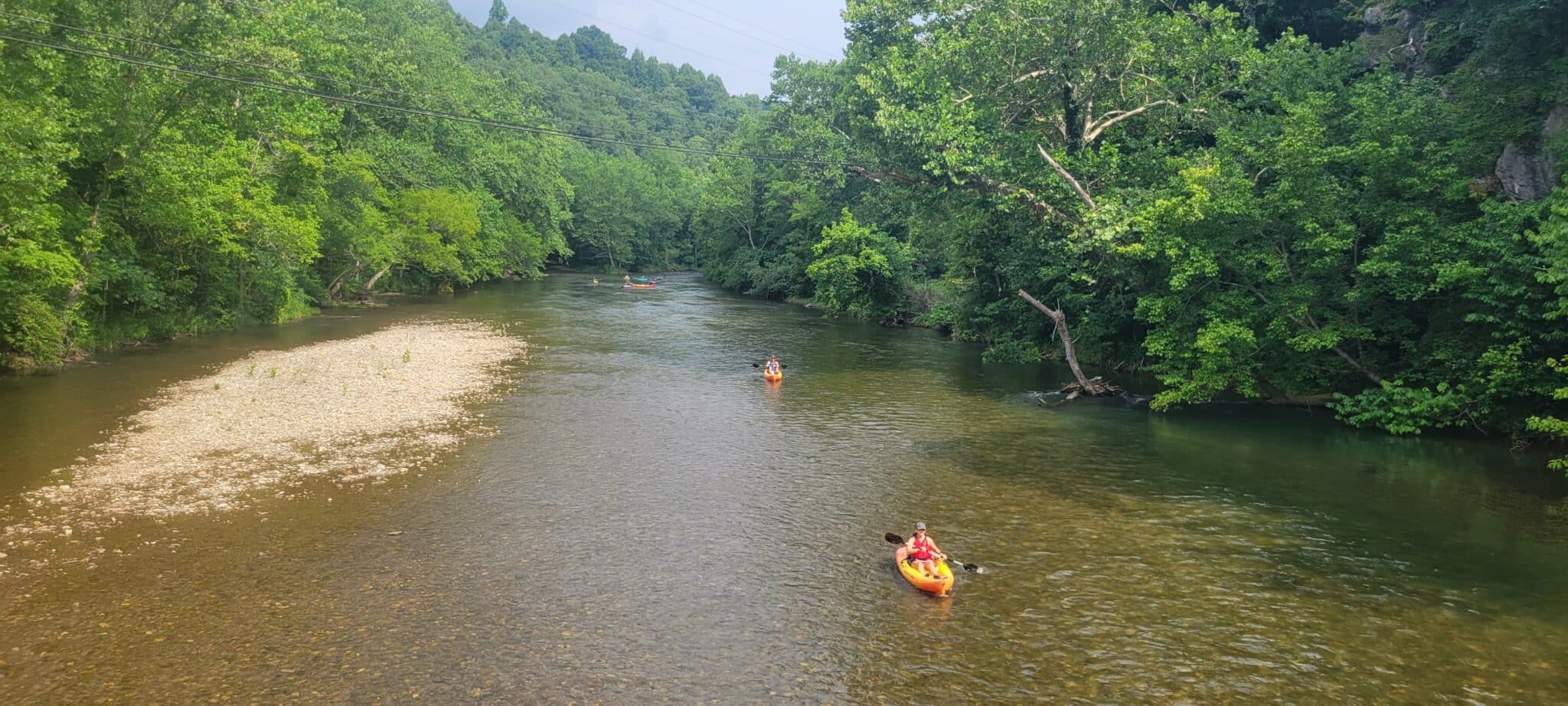 Kayakers paddling the scenic Jackson River in Bath County, Virginia.