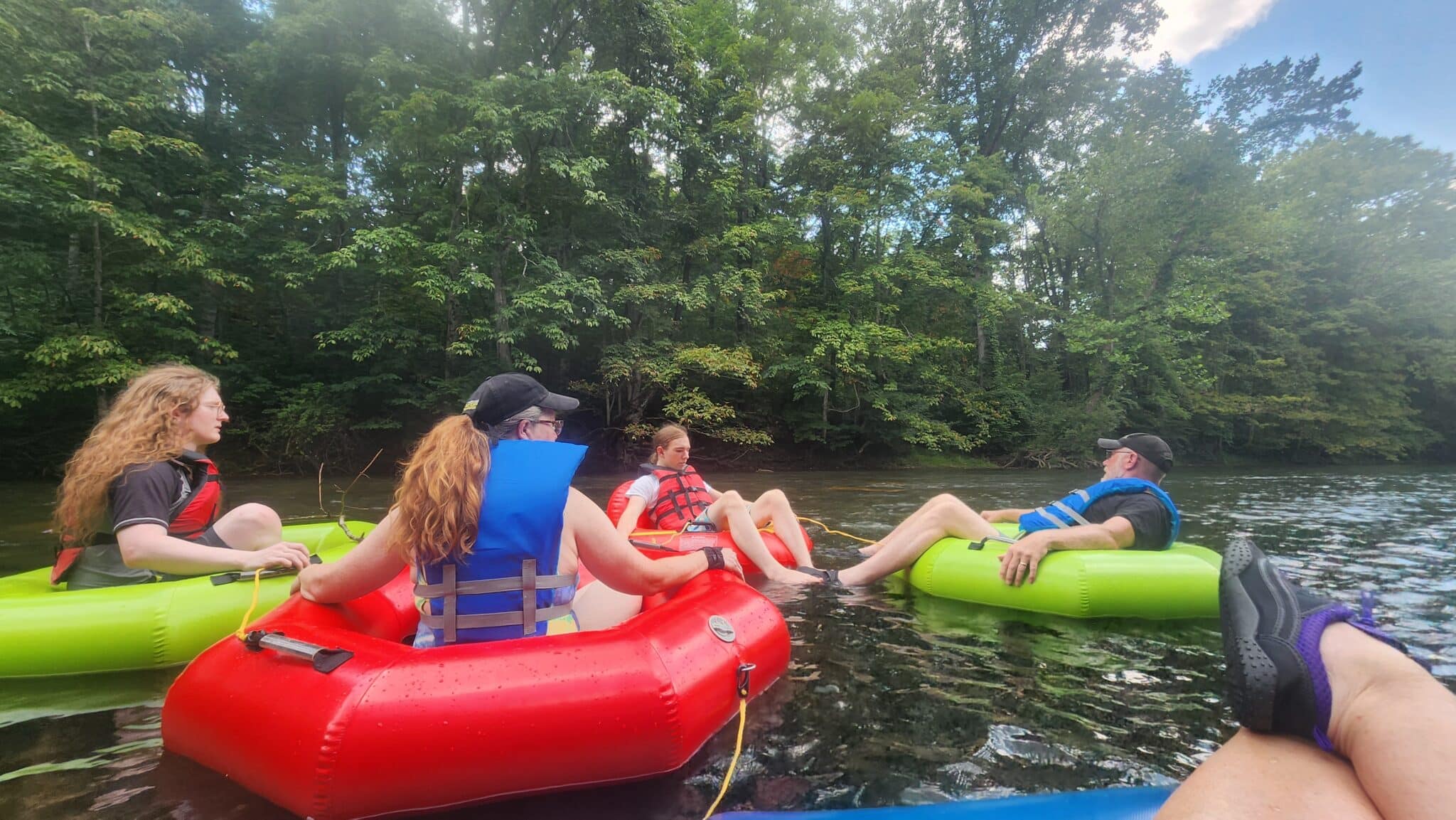 Guests floating the Jackson River during a summer tubing trip in Bath County, Virginia.