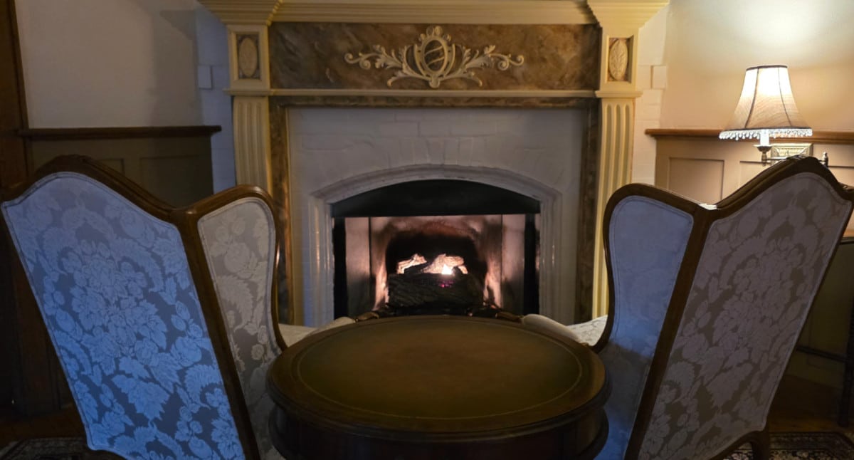 Cozy fireplace seating area at Vine Cottage Inn in Hot Springs, Virginia on a cool mountain evening.