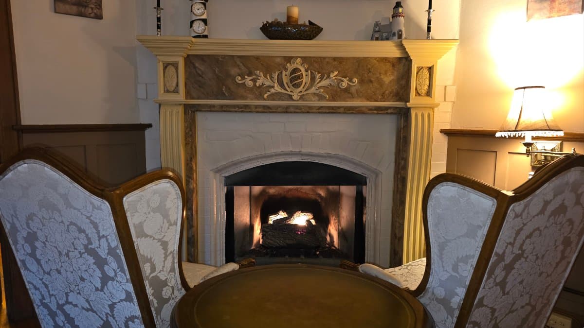 Cozy seating area by the fireplace at Vine Cottage Inn, perfect for a winter getaway in Hot Springs, Virginia