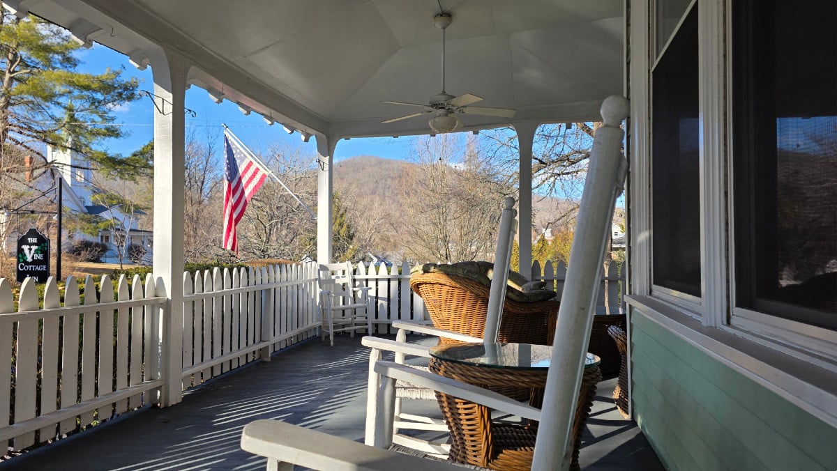 Rocking chairs on the front porch at Vine Cottage Inn overlooking Hot Springs, Virginia in late winter.