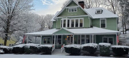 Snow-covered exterior of Vine Cottage Inn, a historic bed and breakfast in Hot Springs, Virginia