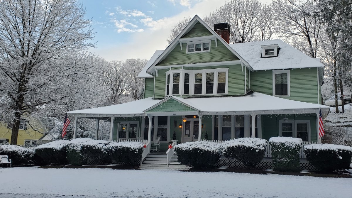 Snow-covered exterior of Vine Cottage Inn, a historic bed and breakfast in Hot Springs, Virginia